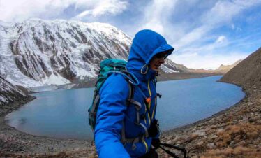 A man taking a sefie at the shore of Tilicho lake in Himalayas